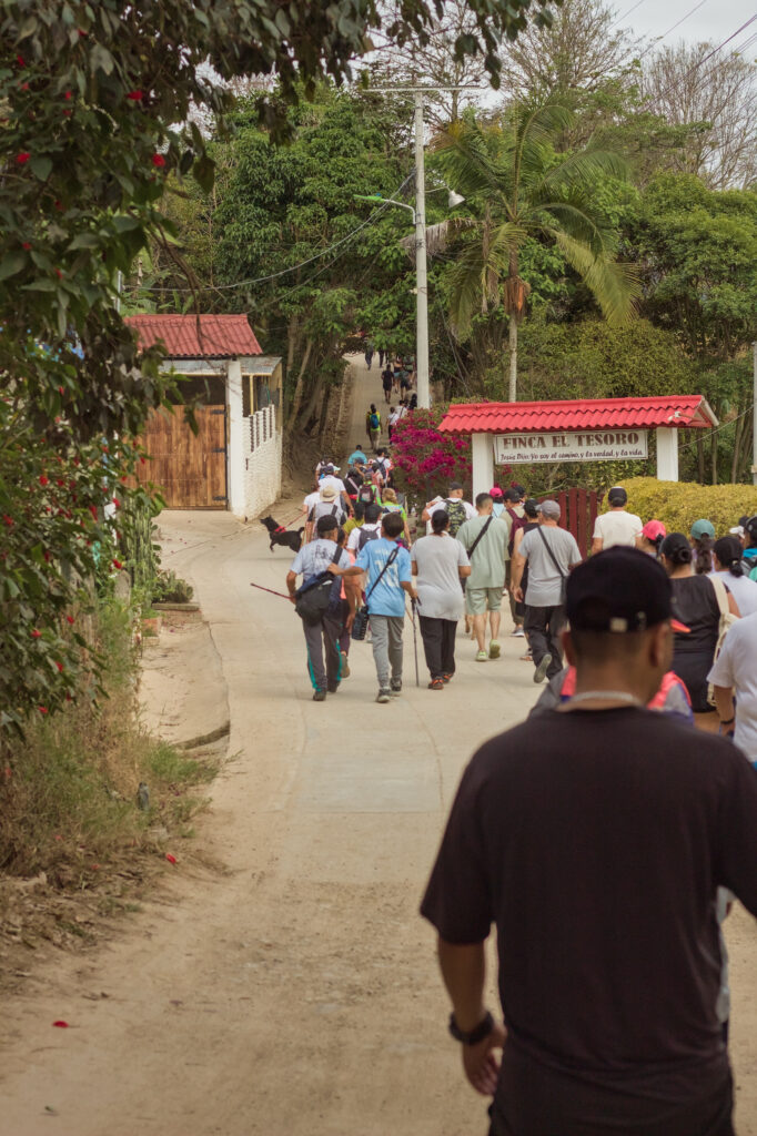 Caminata Tres Esquinas en Fusagasugá: Crónica, Ruta y Fotos (2026) 11 Caminantes subiendo por placa huella frente al porton rústico de la Finca El Tesoro en Cucharal Fusagasuga